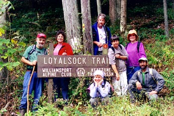 Photo of Loyalsock trail sign with people